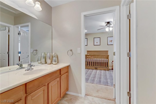 bathroom with vanity, tile patterned floors, baseboards, and ceiling fan