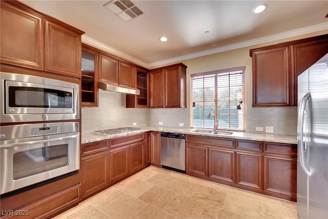 kitchen featuring light stone countertops, visible vents, a sink, under cabinet range hood, and appliances with stainless steel finishes