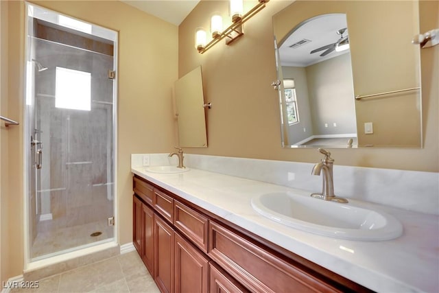 bathroom with a sink, visible vents, a ceiling fan, and a shower stall