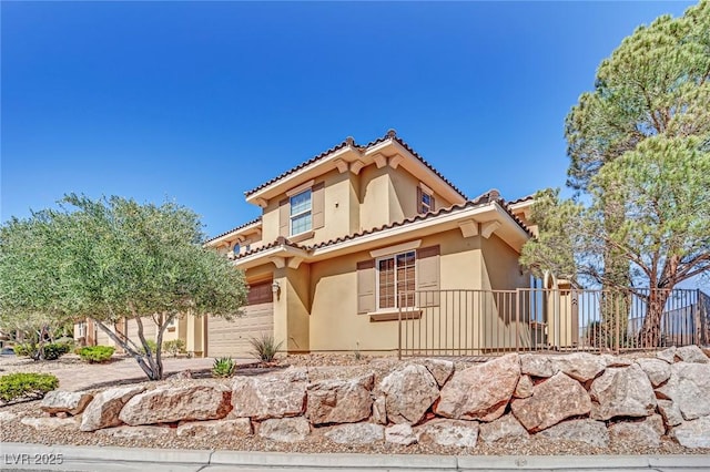 exterior space with stucco siding, a tiled roof, concrete driveway, and a garage