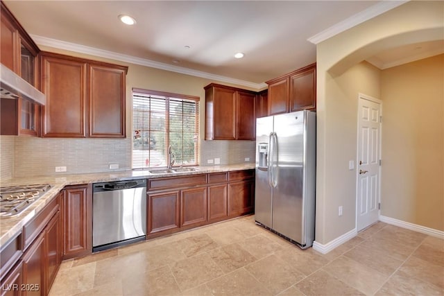 kitchen with wall chimney range hood, ornamental molding, light stone counters, appliances with stainless steel finishes, and a sink