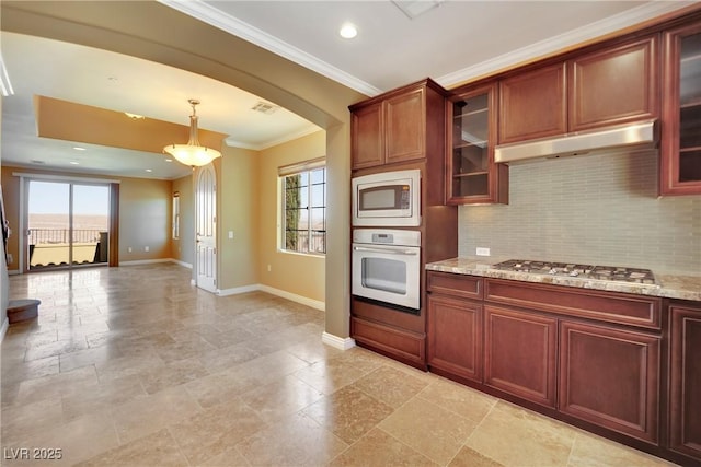 kitchen with under cabinet range hood, a healthy amount of sunlight, appliances with stainless steel finishes, and baseboards