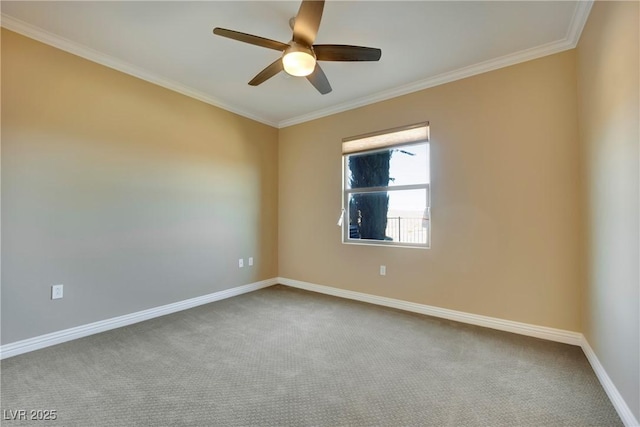 carpeted spare room featuring baseboards, ornamental molding, and a ceiling fan