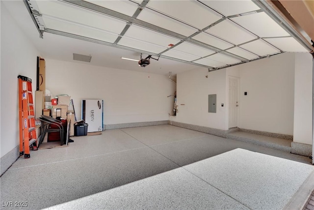 garage featuring electric panel, a garage door opener, and baseboards