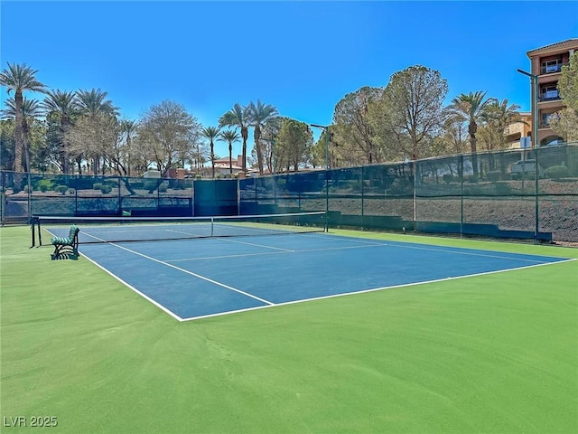 view of tennis court featuring fence