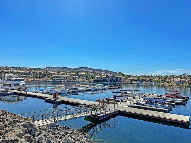 view of dock with a water and mountain view