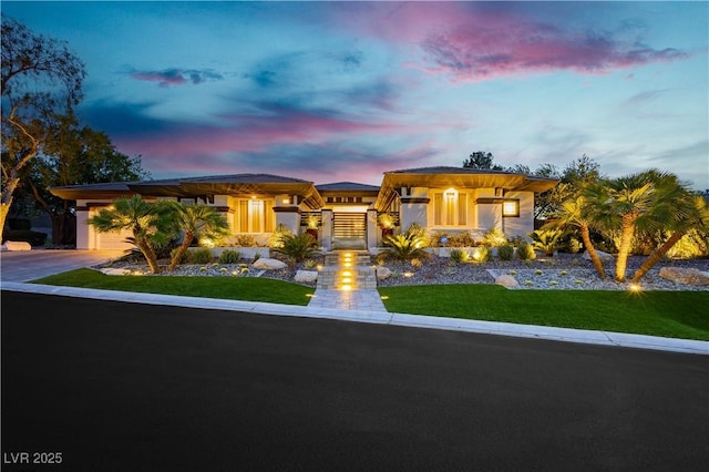 prairie-style home featuring a yard and driveway