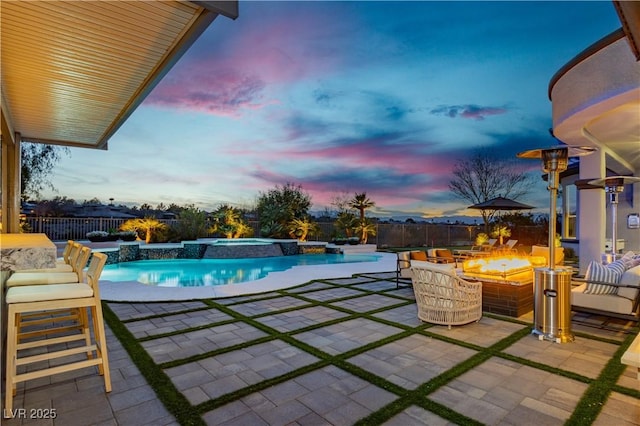 view of swimming pool featuring a fenced in pool, an outdoor fire pit, an in ground hot tub, a fenced backyard, and a patio area