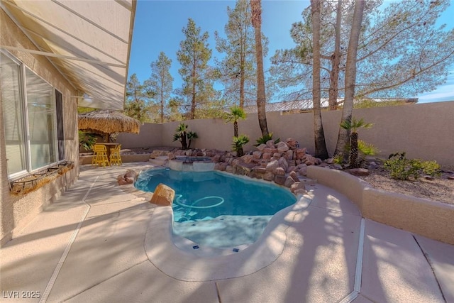 view of swimming pool featuring a patio area, a fenced in pool, and a fenced backyard