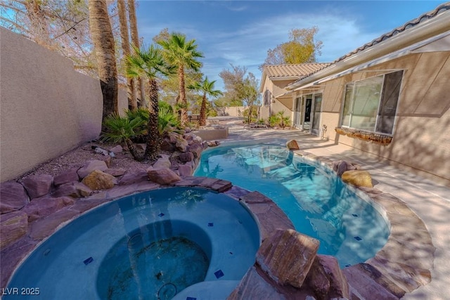 view of pool featuring a patio area, a fenced in pool, an in ground hot tub, and a fenced backyard