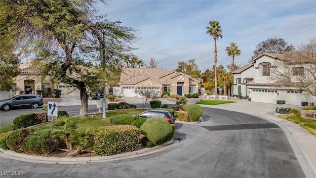 view of front facade featuring a residential view, driveway, and a garage