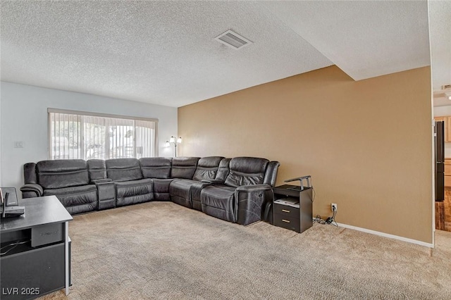 living area with visible vents, baseboards, carpet, and a textured ceiling