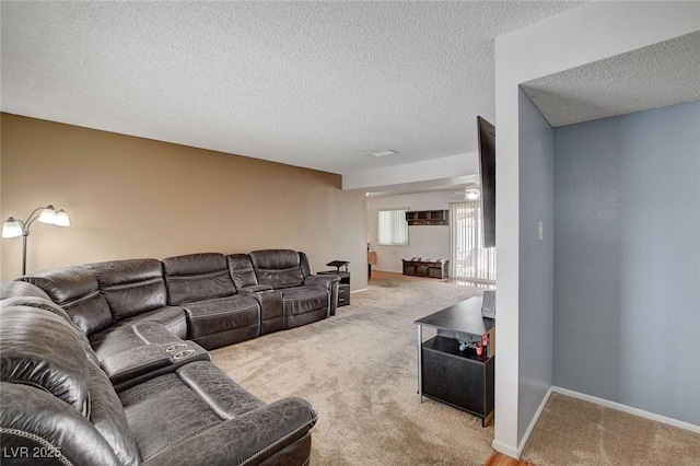 carpeted living room with a textured ceiling and baseboards