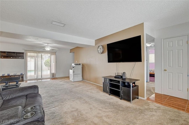 carpeted living area featuring a textured ceiling and ceiling fan