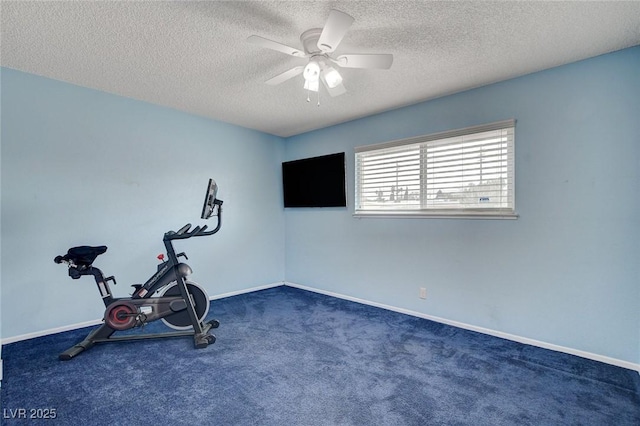 exercise room with a textured ceiling, baseboards, carpet, and a ceiling fan