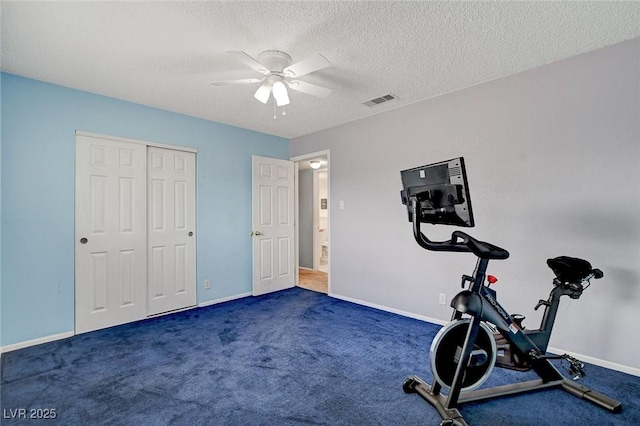 exercise area featuring ceiling fan, baseboards, visible vents, and a textured ceiling