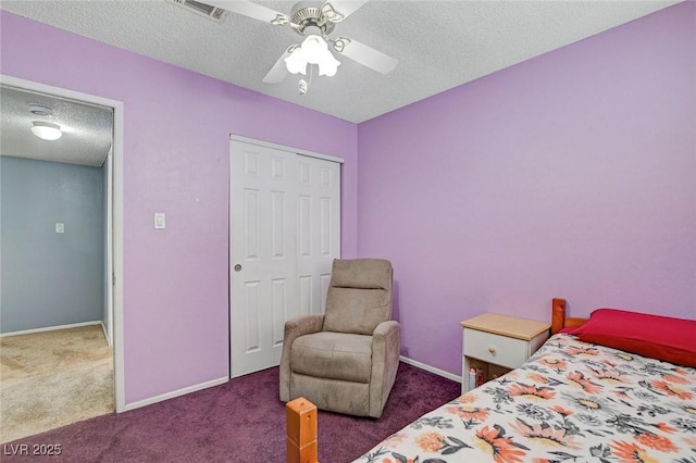 carpeted bedroom with a closet, visible vents, a textured ceiling, and baseboards