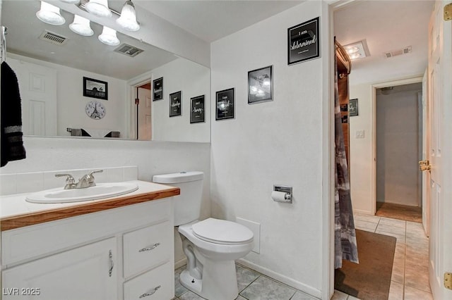 bathroom with tile patterned flooring, toilet, and visible vents