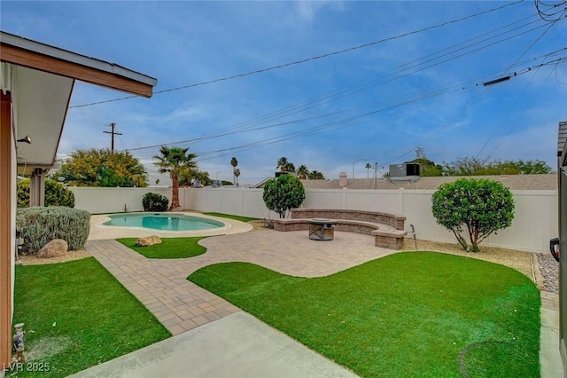 view of yard with a patio area, a fenced in pool, a fenced backyard, and a fire pit