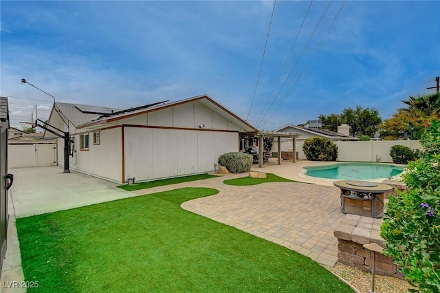 exterior space with a fenced in pool, a patio, a fire pit, and a fenced backyard