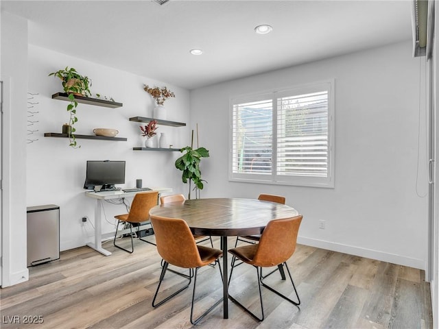 dining space featuring recessed lighting, baseboards, and light wood finished floors