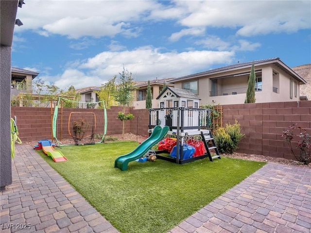 view of jungle gym featuring a yard and a fenced backyard