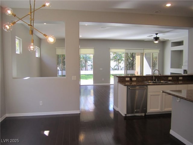 kitchen with dishwasher, plenty of natural light, open floor plan, and a sink