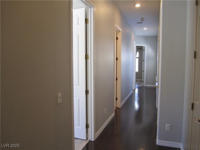 hallway featuring recessed lighting, dark wood-style floors, and baseboards