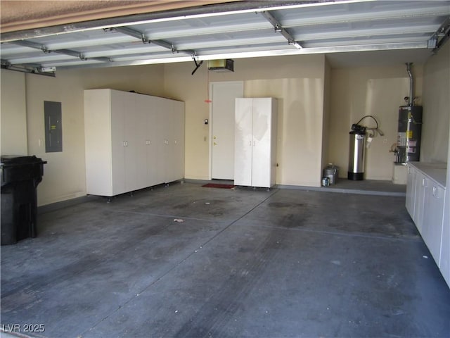 garage with strapped water heater, electric panel, and a garage door opener