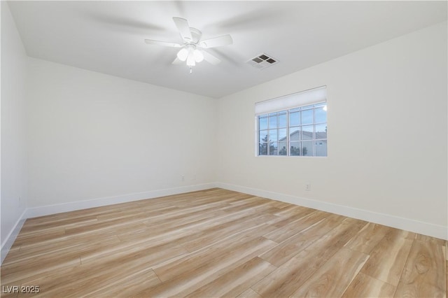 unfurnished room with light wood-type flooring, visible vents, baseboards, and ceiling fan