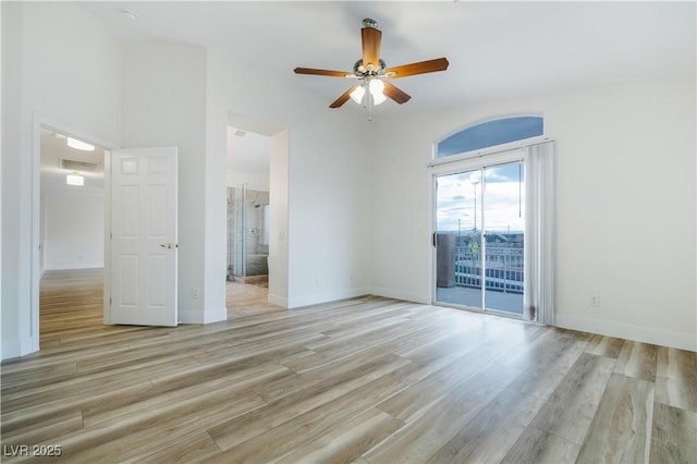 empty room with light wood-type flooring, visible vents, baseboards, and a ceiling fan