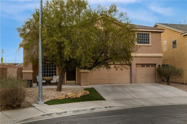 view of front of house with an attached garage, driveway, and stucco siding