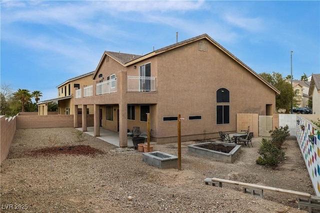 back of property with a patio, a fenced backyard, and stucco siding