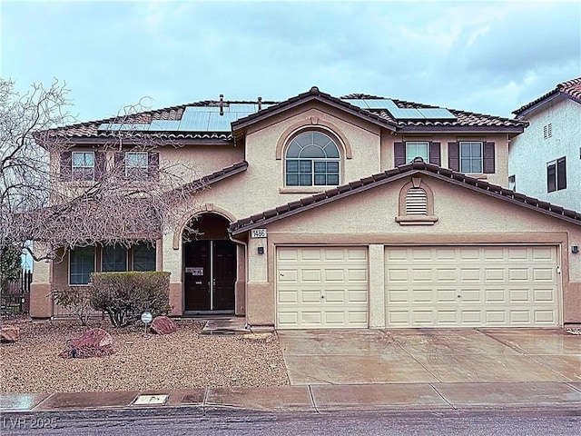 view of front of home with stucco siding, a tiled roof, and concrete driveway