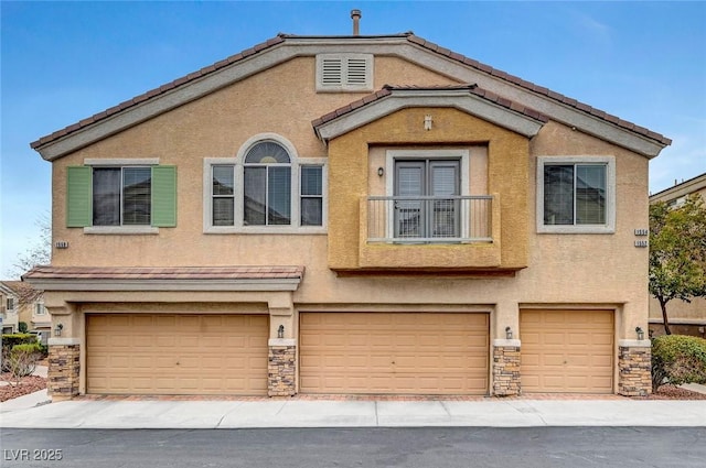 view of front of property with a garage, stone siding, and stucco siding