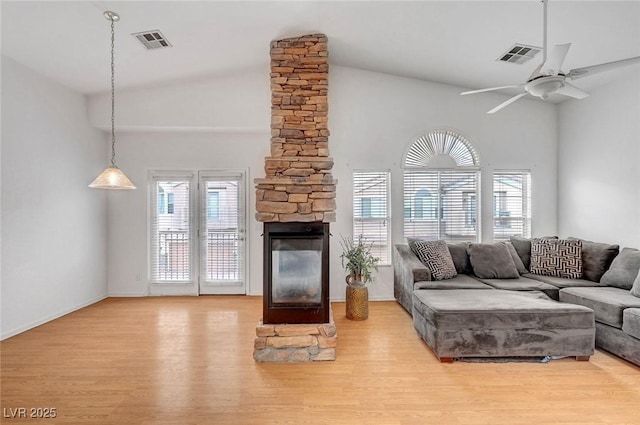 living room featuring wood finished floors, visible vents, and a wealth of natural light