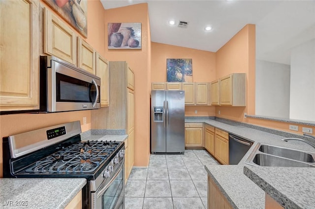 kitchen featuring visible vents, light brown cabinets, light countertops, appliances with stainless steel finishes, and a sink