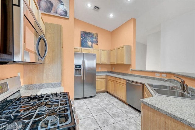 kitchen with light brown cabinets, visible vents, light tile patterned flooring, a sink, and appliances with stainless steel finishes