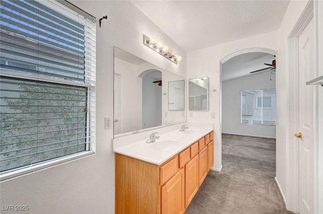 bathroom with double vanity, ceiling fan, and a sink