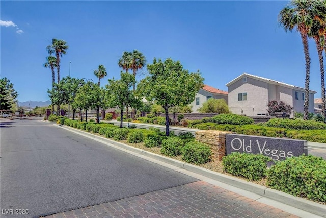 view of road with curbs and a gated entry