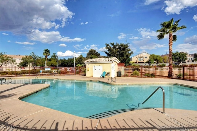 pool with a patio and fence