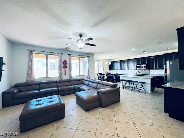 living area with light tile patterned floors, visible vents, and a healthy amount of sunlight