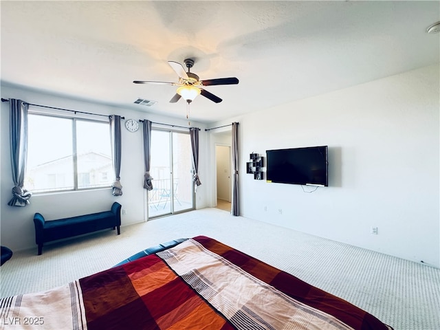 unfurnished bedroom with light carpet, visible vents, a ceiling fan, and access to outside