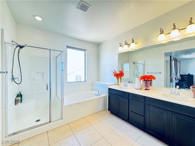 full bathroom featuring a sink, a garden tub, and a shower stall