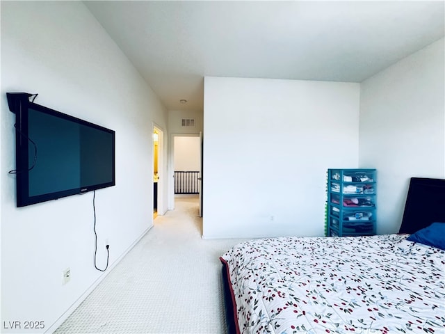 bedroom featuring visible vents and light carpet