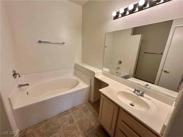 bathroom with vanity and a bath