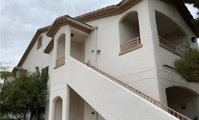 view of home's exterior featuring stucco siding and a tiled roof