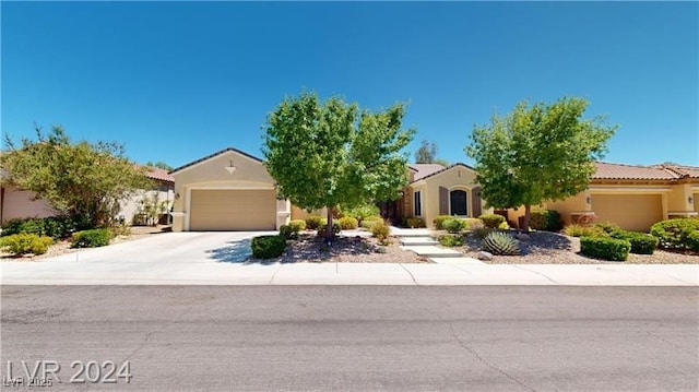 view of front facade with concrete driveway, an attached garage, and stucco siding