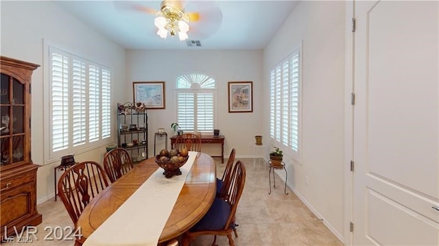 dining area with visible vents, baseboards, and a ceiling fan