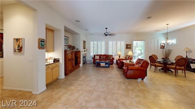 living room with baseboards and ceiling fan